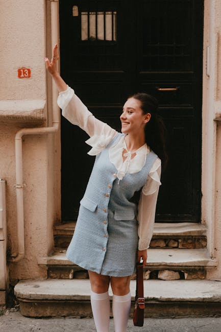 A young woman waving in front of door number 13