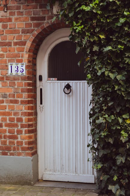 White paneled door with address 135